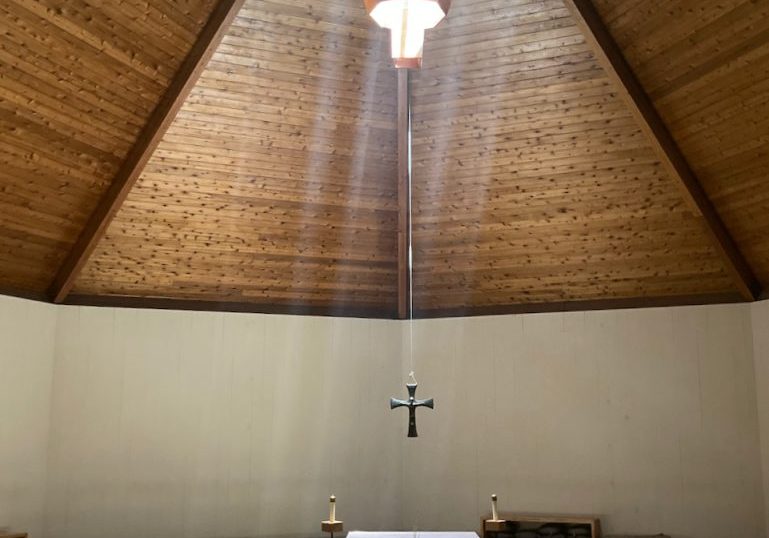 A shaft of light falling across the chapel at New Camaldoli Hermitage